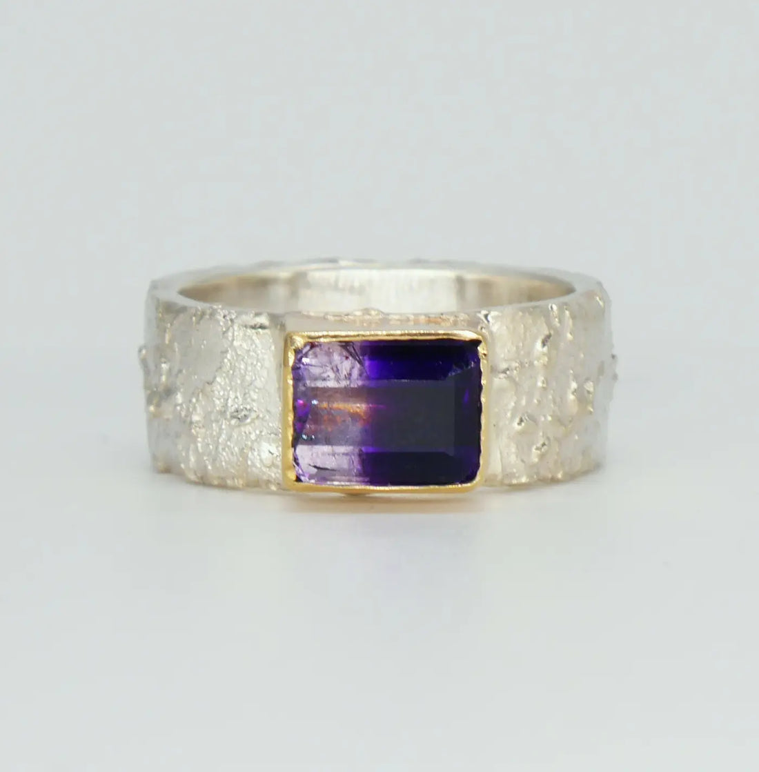 Unique Rivda Bi-colour amethyst silver with a gold setting ring on a white background.
