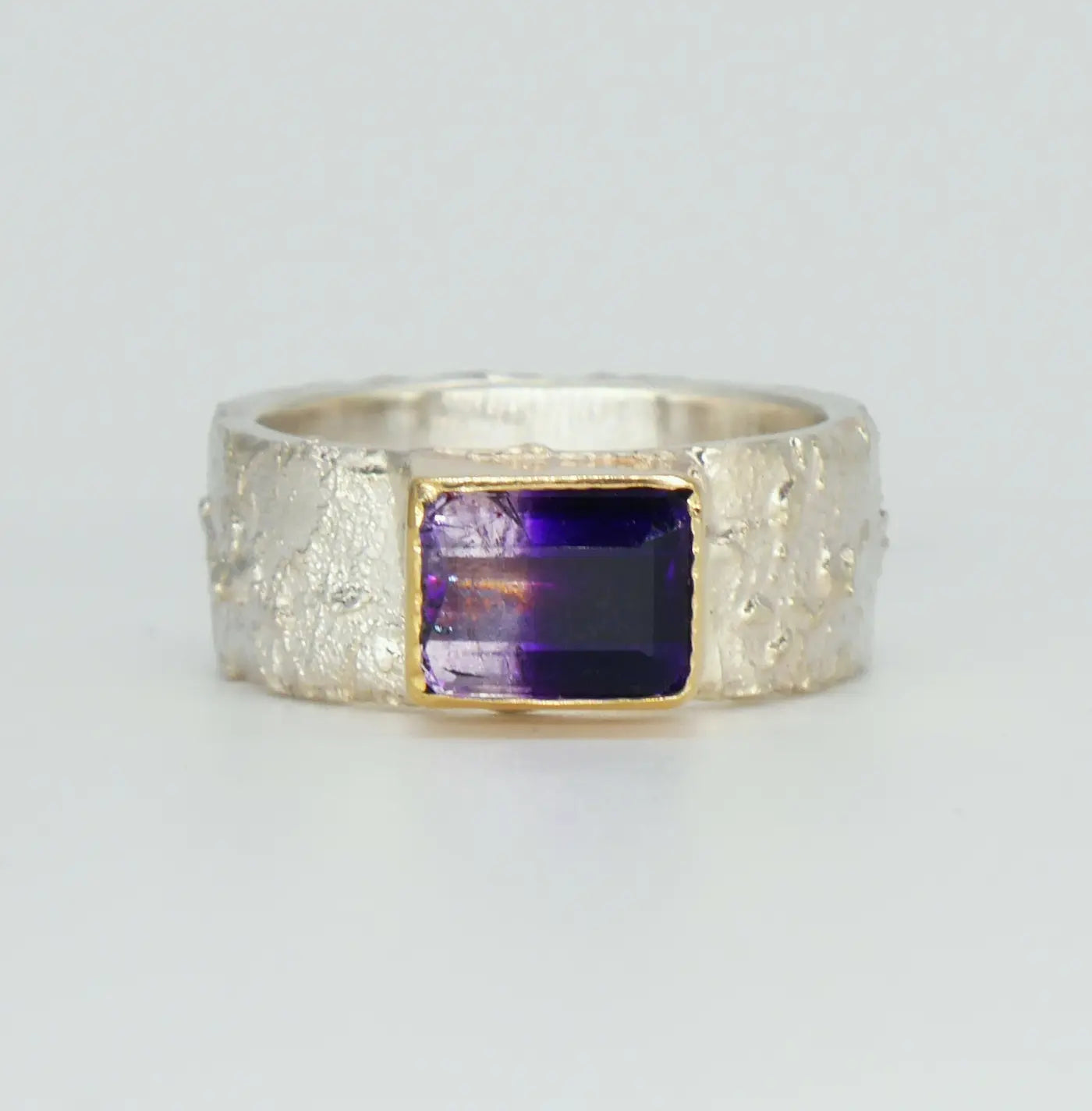 Unique Rivda Bi-colour amethyst silver with a gold setting ring on a white background.