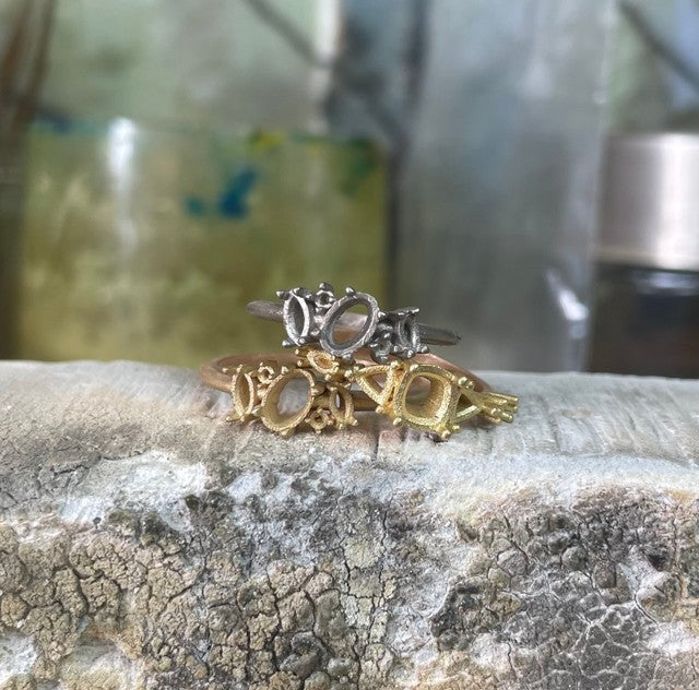 Three gold unset and unpolished rings, white, yellow and rose gold.