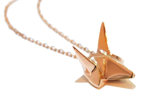 Handmade bespoke rose gold plated silver fox pendant with a white background