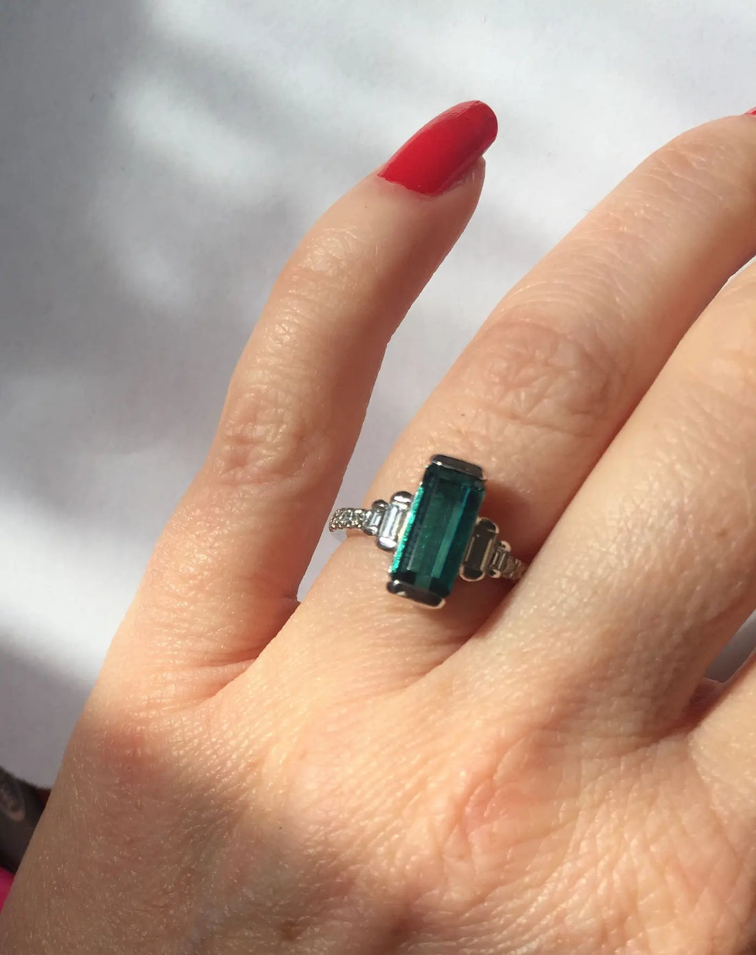Bespoke green tourmaline engagement ring with diamond side stones