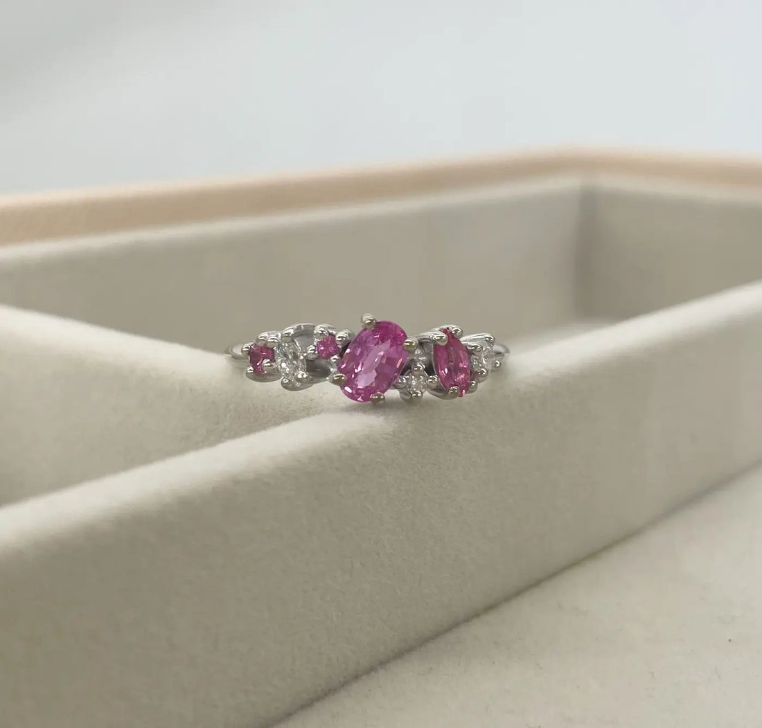 Pink sapphire bespoke Atlantis Paradise engagement ring on velvet tray — handmade by Nude Jewellery London