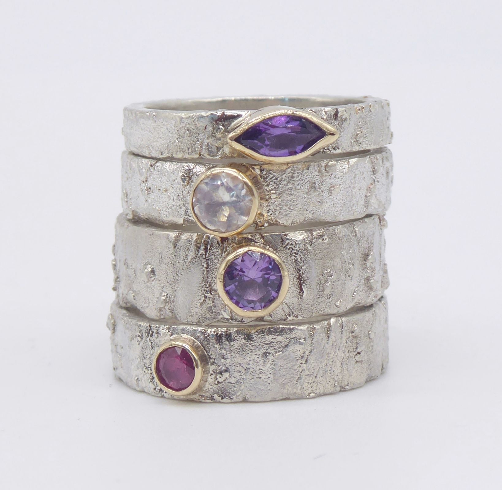 Stacked group of handmade Rivda silver rings with gemstones
