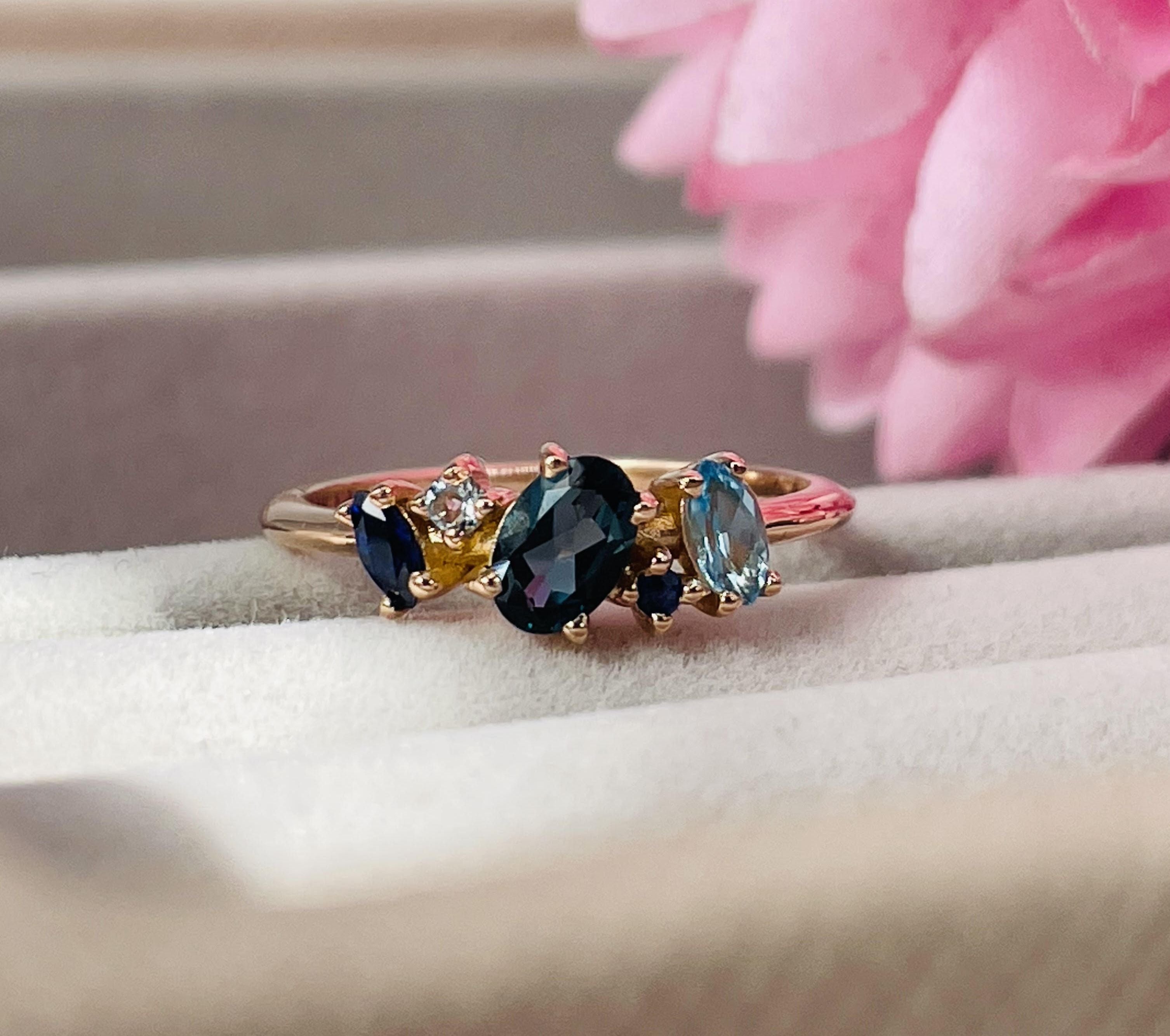 Atlantis Asymmetry Collection — multi-stone sapphire and diamond cluster engagement ring on hand, handmade in London