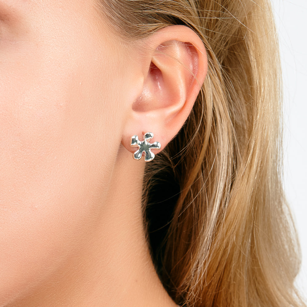 Small silver earrings on a model
