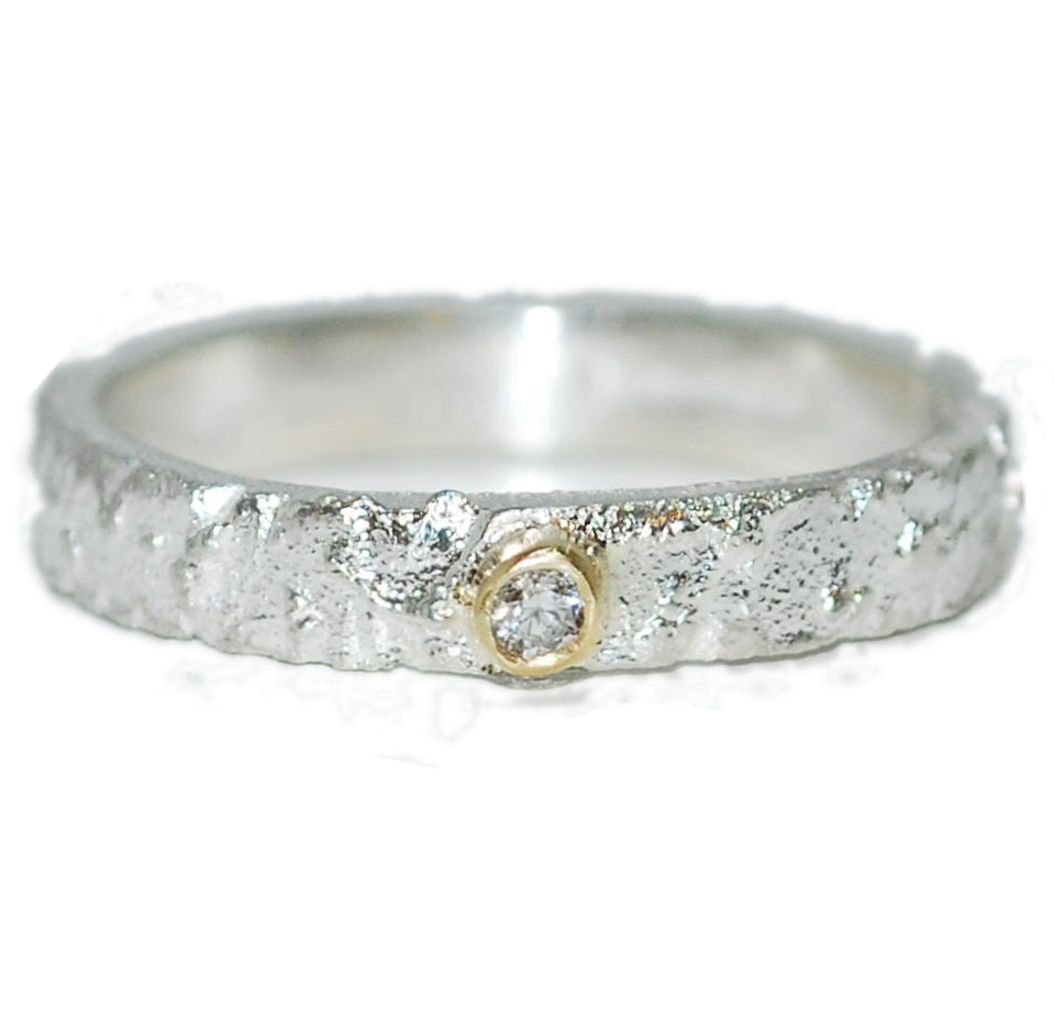 Unique Textured Silver Ring Featuring A Diamond Set In Gold