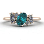 Front view of the Atlantis engagement ring, featuring an organic, asymmetrical cluster of ocean-toned teal sapphires and sparkling white diamonds in 18ct rose gold.