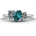 Front view of the Atlantis engagement ring, featuring an asymmetrical cluster of ocean-hued teal sapphires and brilliant diamonds set in platinum or white gold.