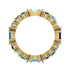Overhead view of the blue sapphire and aquamarine eternity ring illustrating the alternating pattern of marquise and round-cut gemstones.