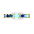 Macro detail of the True Blue ring showcasing the contrast between the deep blue sapphires and the light blue tones of the aquamarine and topaz.