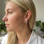 Model wearing 14mm sterling silver handmade Vanilla stud earrings, showing the textured finish.