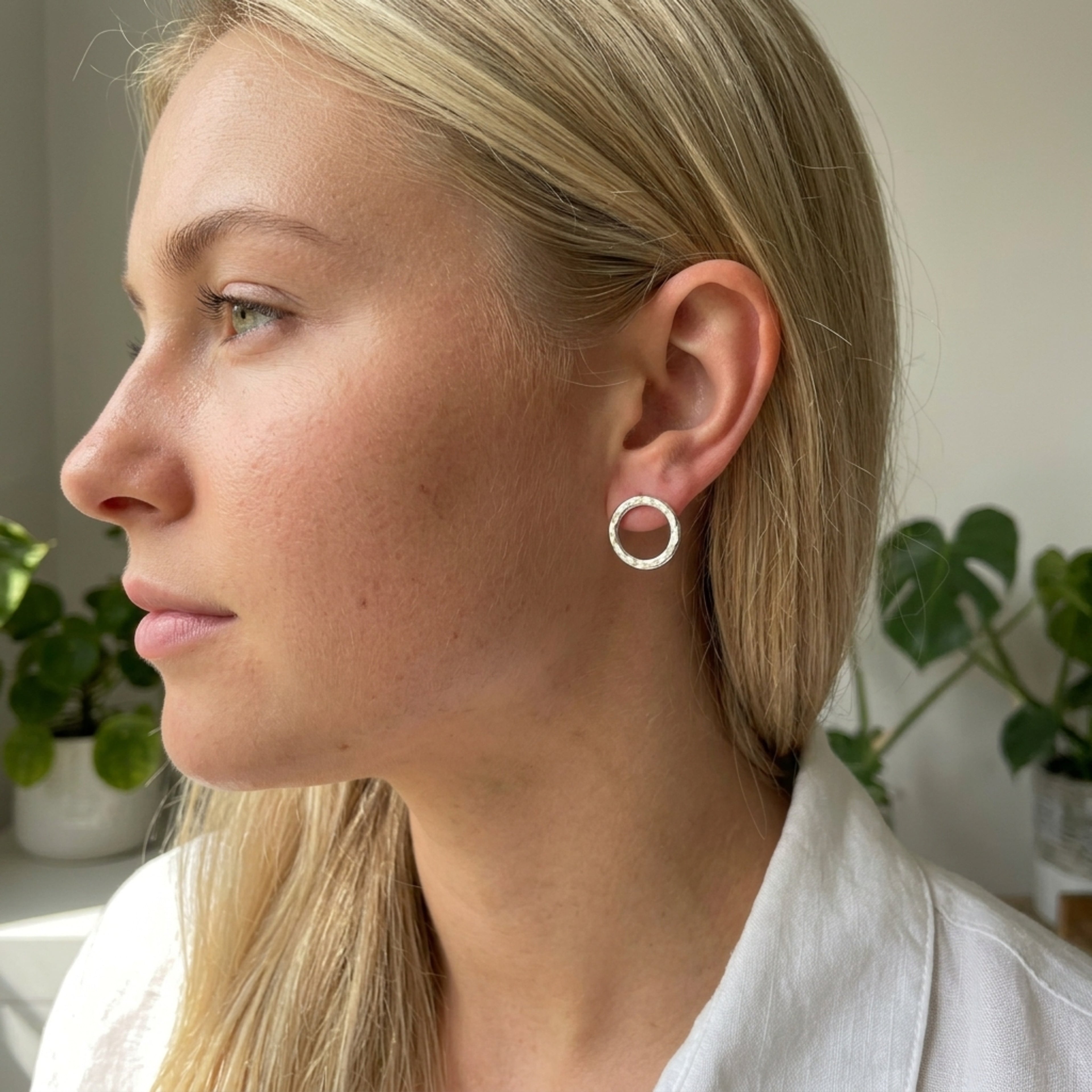 Model wearing 14mm sterling silver handmade Vanilla stud earrings, showing the textured finish.