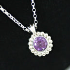 Alto Majestic amethyst and recycled silver pendant on a black background, showing deep purple brilliant-cut stone and polished millgrain beaded silver frame on a trace chain