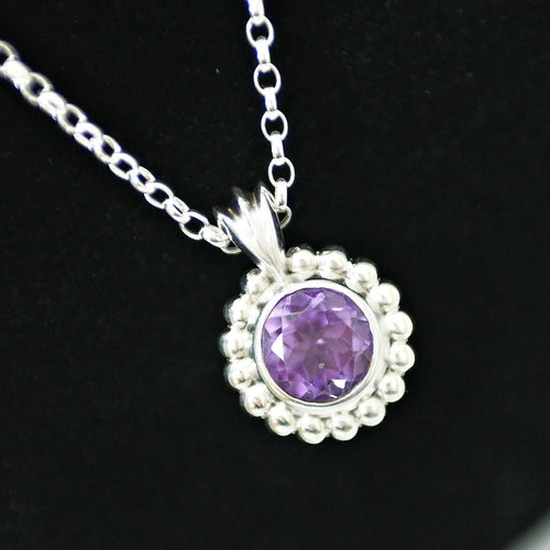 Alto Majestic amethyst and recycled silver pendant on a black background, showing deep purple brilliant-cut stone and polished millgrain beaded silver frame on a trace chain
