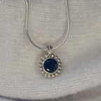 A front-facing view of the Alto Majestic pendant, featuring a round, brilliant-cut black spinel gemstone set within a high-polished recycled silver geometric frame.
