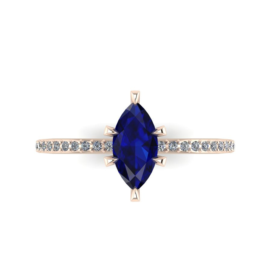 Top-down view of the Amoret ring showing the symmetrical marquise blue sapphire and the brilliant-cut diamond shoulders.