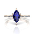 Profile view of the Amoret engagement ring showing the elegant silhouette of the marquise blue sapphire and the diamond-set rose gold band.