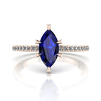Profile view of the Amoret engagement ring showing the elegant silhouette of the marquise blue sapphire and the diamond-set rose gold band.