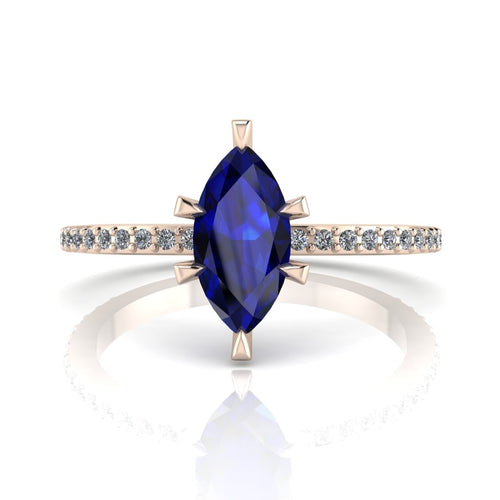 Profile view of the Amoret engagement ring showing the elegant silhouette of the marquise blue sapphire and the diamond-set rose gold band.