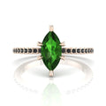 Front profile view of the Amoret green tourmaline ring in 18ct rose gold showing the marquise silhouette and grain-set black diamond shoulders.
