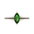 Top-down view of the Amoret ring showing the symmetrical marquise green tourmaline and the dark allure of the black diamond shoulders.