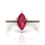 Profile view of the Amoret ruby ring in 18ct rose gold showing the marquise silhouette and grain-set black diamond shoulders.