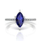Profile view of the Amoret sapphire ring in 18ct white gold or platinum showing the elegant marquise silhouette and grain-set diamond shoulders.