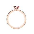 A through-finger view of the Amoret ruby and black diamond ring showing the internal band and clean setting symmetry.