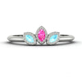 Front view of the Astraea Echo trilogy ring featuring an aquamarine centre and pink sapphire marquise shoulders in white gold.