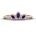 Front view of the Astraea Echo trilogy ring in 18ct rose gold featuring a central blue sapphire and two diamond shoulders.