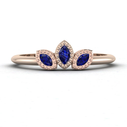Front view of the Astraea Echo trilogy ring in 18ct rose gold featuring a central blue sapphire and two diamond shoulders.