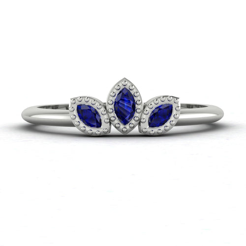 Front view of the Astraea Echo trilogy ring featuring a blue sapphire centre and blue sapphire marquise shoulders in white gold or platinum.