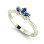 Side profile view of the Astraea Echo blue sapphire ring showing the architectural white gold setting and the depth of the gemstones.