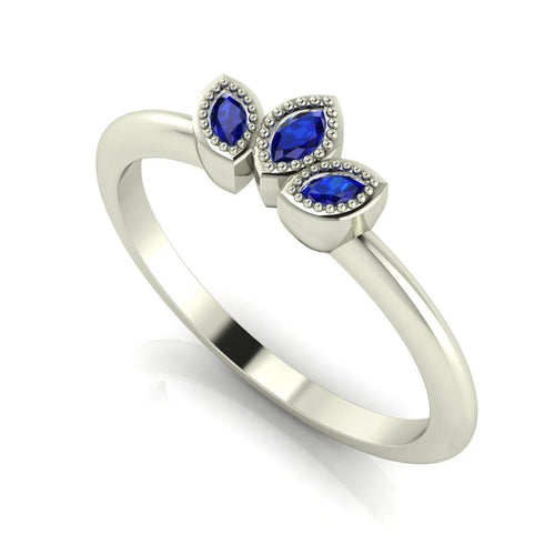 Side profile view of the Astraea Echo blue sapphire ring showing the architectural white gold setting and the depth of the gemstones.