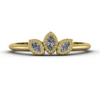 Front view of the Astraea Echo trilogy ring featuring a brilliant-cut diamond centre and marquise diamond shoulders in 18ct yellow gold.
