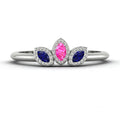 Front view of the Astraea Echo trilogy ring featuring a pink sapphire centre and blue sapphire marquise shoulders in white gold.