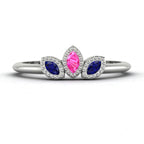 Front view of the Astraea Echo trilogy ring featuring a pink sapphire centre and blue sapphire marquise shoulders in white gold.