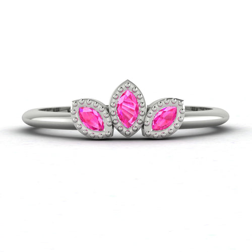 Front view of the Astraea Echo trilogy ring featuring a vibrant pink sapphire and two brilliant-cut diamond shoulders.