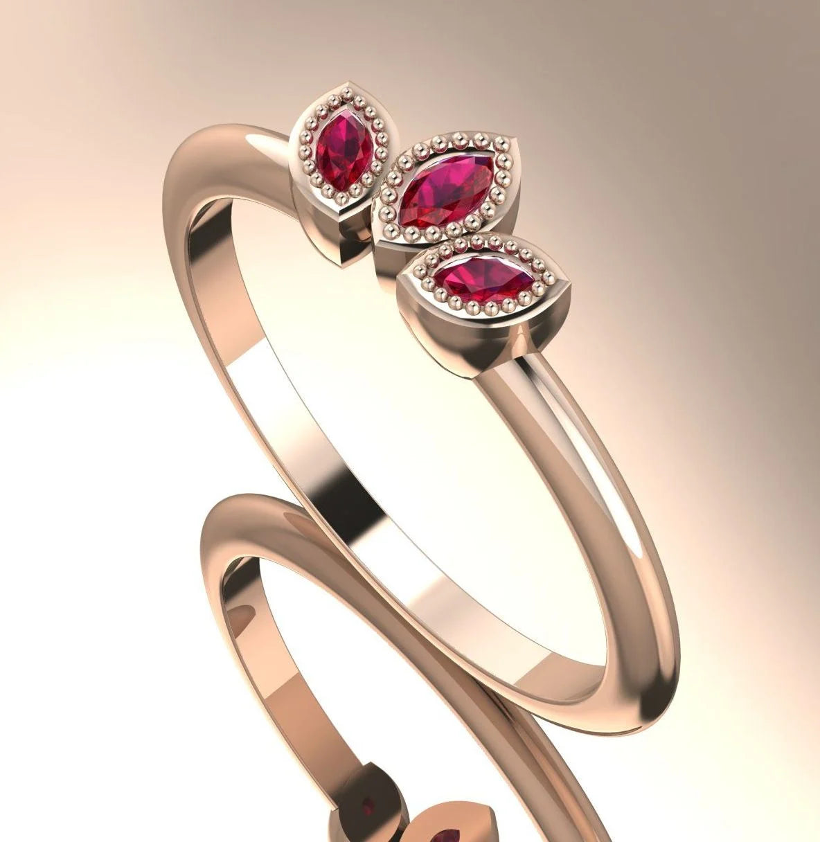 Profile view of the Astraea Echo trilogy ring featuring a ruby centre and ruby marquise shoulders in 18ct rose gold.