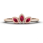 Front view of the Astraea Echo trilogy ring featuring a ruby centre and ruby marquise shoulders in 18ct rose gold.