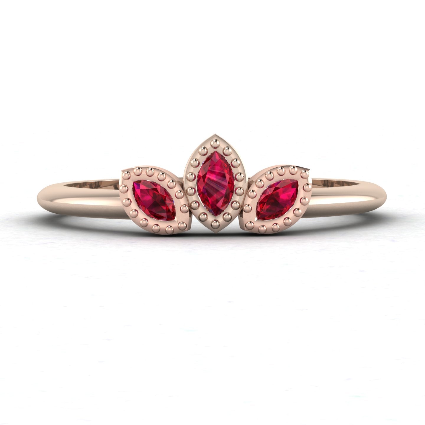Front view of the Astraea Echo trilogy ring featuring a ruby centre and ruby marquise shoulders in 18ct rose gold.