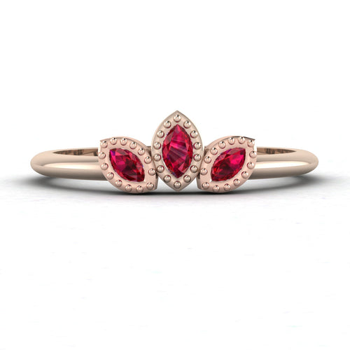 Front view of the Astraea Echo trilogy ring featuring a ruby centre and ruby marquise shoulders in 18ct rose gold.
