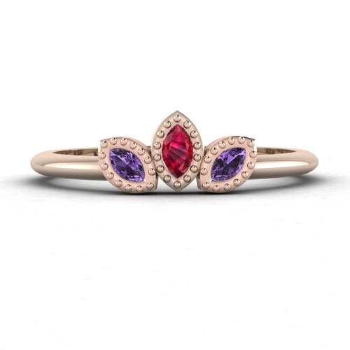 Front view of the Astraea Echo trilogy ring featuring a violet sapphire centre and ruby marquise shoulders in 18ct rose gold.