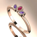 Side profile view of the Astraea Echo ring showing the architectural rose gold setting and the depth of the violet sapphire and rubies.