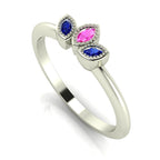 Profile view of the Astraea Echo trilogy ring featuring a pink sapphire centre and blue sapphire marquise shoulders in white gold.