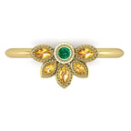 Top view of Astraea Liberty gold ring with a central emerald and marquise yellow sapphires in a floral cluster.