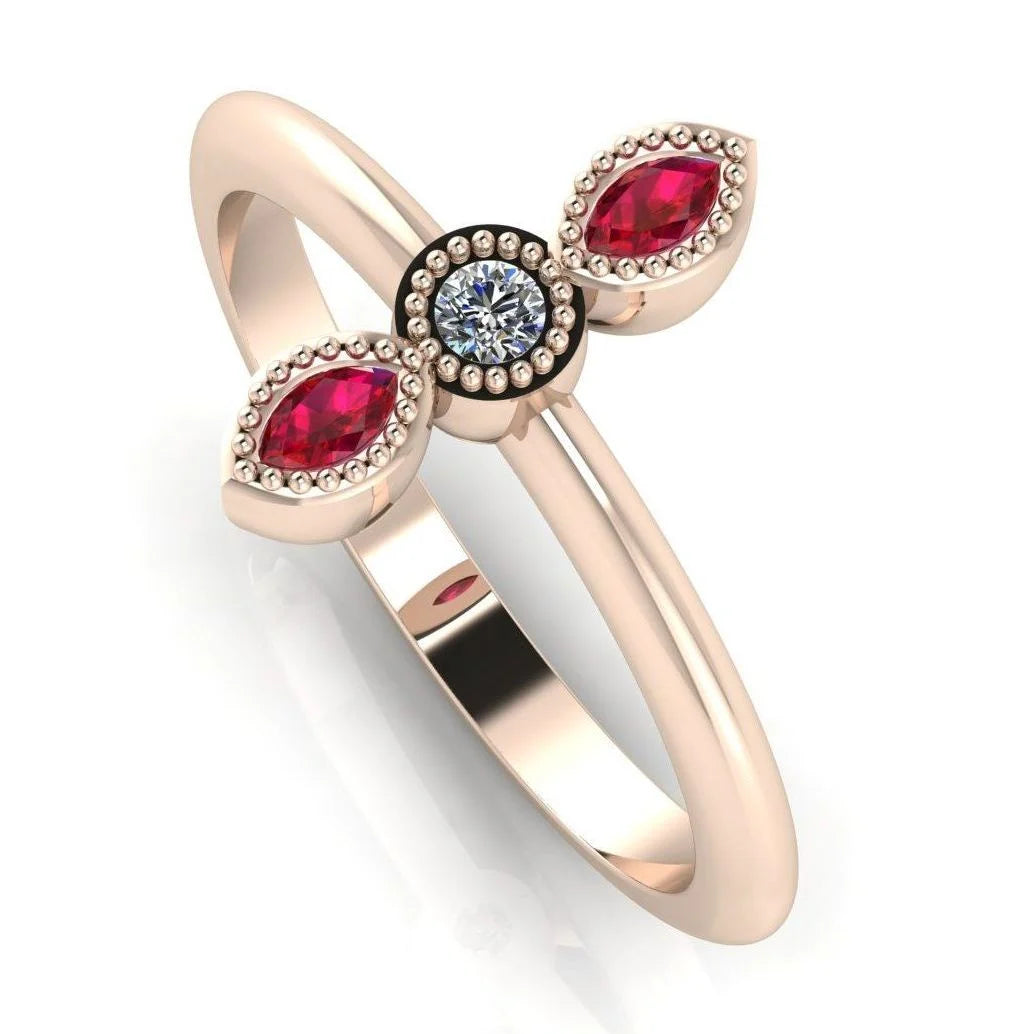 Angled perspective of an 18ct rose gold trilogy ring featuring a diamond and two rubies with fine milgrain texture.