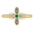 Top view of Astraea Trilogy 18ct yellow gold ring featuring a central emerald and two sparkling diamonds.