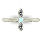 Top down view of an Astraea Trilogy ring with a central round diamond flanked by two horizontal marquise aquamarines in 18ct white gold.