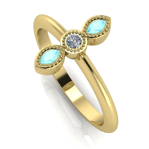 An angled perspective showcasing the unique marquise shape of the aquamarines and the warmth of the polished yellow gold band.